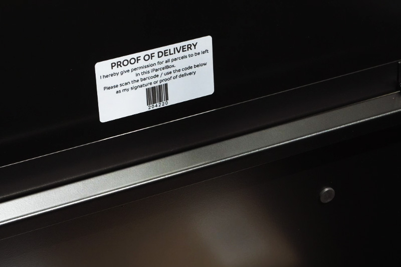 A label fixed inside the lid of the iParcelBox giving permission for parcels to be left inside the smart parcel delivery box, with a unique barcode.