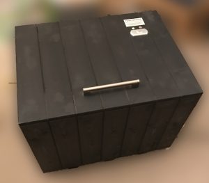 A photograph of the Founder Paul Needler's first parcel delivery box, made from wood and salvaged parts in his garage.
